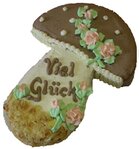 Cremtorte in Form eines Pilzes mit der Aufschrift Viel Glück